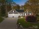 Charming single-Gathering home with a well-manicured lawn, mature trees, and an attached two-car garage at 10009 Lattice Ct, Charlotte, NC 28269