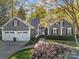 Charming single-Gathering home with a well-manicured lawn, mature trees, and an attached two-car garage at 10009 Lattice Ct, Charlotte, NC 28269