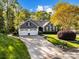 Charming single-Gathering home with a well-manicured lawn, mature trees, and an attached two-car garage at 10009 Lattice Ct, Charlotte, NC 28269