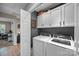 Well-lit laundry room features a new washer, dryer, and custom storage cabinets at 10009 Lattice Ct, Charlotte, NC 28269