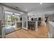 Bright living room with bar seating, a screen porch, and an open floorplan at 10009 Lattice Ct, Charlotte, NC 28269