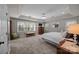 Spacious main bedroom features a ceiling fan, sitting area, and plenty of natural light at 10009 Lattice Ct, Charlotte, NC 28269