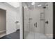 Modern tiled shower with glass door, rain shower head, and built-in niche at 10009 Lattice Ct, Charlotte, NC 28269