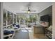 Screened sunroom with tile flooring, comfortable seating, and views of the backyard at 10009 Lattice Ct, Charlotte, NC 28269