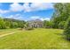 Expansive backyard featuring a pergola, hot tub, fire pit, and ample lawn space, perfect for outdoor entertaining at 10012 Royal Colony Dr, Waxhaw, NC 28173