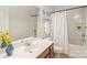 Bright bathroom features a large mirror, single sink, and shower tub combination at 10012 Royal Colony Dr, Waxhaw, NC 28173