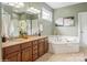 Well-appointed bathroom with double vanity, soaking tub, and modern fixtures at 10012 Royal Colony Dr, Waxhaw, NC 28173