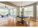 Charming dining area featuring a modern table, bright windows, and adjacent living space at 10012 Royal Colony Dr, Waxhaw, NC 28173