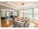 Open concept dining area with a chandelier and views into the adjacent living room at 10012 Royal Colony Dr, Waxhaw, NC 28173