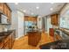 Spacious kitchen with island, stainless steel appliances, and custom wood cabinetry at 10012 Royal Colony Dr, Waxhaw, NC 28173