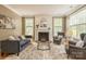 Cozy living room with a fireplace, neutral decor, and plenty of natural light at 10012 Royal Colony Dr, Waxhaw, NC 28173