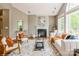 Comfortable living room with fireplace, hardwood floors, and large windows for natural light at 10012 Royal Colony Dr, Waxhaw, NC 28173