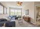 Cozy living room with blue sectional sofa and ample natural light at 10012 Royal Colony Dr, Waxhaw, NC 28173