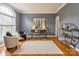 Elegant living room with hardwood floors, desk, decor and neutral wall color at 10012 Royal Colony Dr, Waxhaw, NC 28173