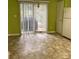 Eat-in kitchen with linoleum flooring, sliding doors to patio, a chandelier, and adjacent white refrigerator at 1012 Kings Mountain Ln, Gastonia, NC 28054