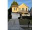 Charming two-story home features a front-facing garage and a welcoming front porch with dark green door and shutters at 1012 Kings Mountain Ln, Gastonia, NC 28054