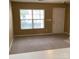 Bright living room featuring neutral walls, carpet flooring, and a large window that brings in natural light at 1012 Kings Mountain Ln, Gastonia, NC 28054
