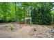 Landscaped backyard featuring a charming garden, stone walkway, and lush greenery for a serene outdoor space at 10319 Remembrance Trl, Huntersville, NC 28078