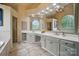 Spacious bathroom with double vanity, arched windows, and elegant tile flooring at 10319 Remembrance Trl, Huntersville, NC 28078