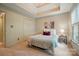 Cozy bedroom with tray ceiling, closet and side table with lamp at 10319 Remembrance Trl, Huntersville, NC 28078
