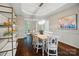 Formal dining room with elegant chandelier and view of the adjacent living room at 10319 Remembrance Trl, Huntersville, NC 28078