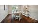 Dining room with hardwood floors, chandelier, and view to shelves at 10319 Remembrance Trl, Huntersville, NC 28078