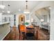 Warm dining room with hardwood floors sits next to the kitchen and staircase at 10319 Remembrance Trl, Huntersville, NC 28078