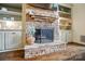 Stacked stone fireplace with a decorative mantle and built-in bookshelves at 10319 Remembrance Trl, Huntersville, NC 28078