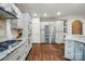Spacious kitchen boasts stainless steel appliances, granite countertops, and hardwood floors at 10319 Remembrance Trl, Huntersville, NC 28078