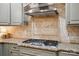 Granite countertops complement the stainless steel range and stylish backsplash in the kitchen at 10319 Remembrance Trl, Huntersville, NC 28078