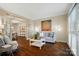 Comfortable living room featuring wood floors, a sofa, and french doors at 10319 Remembrance Trl, Huntersville, NC 28078