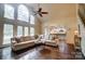 Light-filled living room features a soaring ceiling, fireplace, and hardwood flooring at 10319 Remembrance Trl, Huntersville, NC 28078