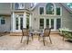 Charming backyard patio with outdoor seating and a view of the home's architectural details at 10319 Remembrance Trl, Huntersville, NC 28078