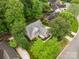 Beautiful aerial view of home showcasing roof, yard, driveway, and surrounding trees at 1033 Marguerite Dr, Lowell, NC 28098