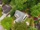 An aerial view of the charming home featuring lush landscaping and a well-maintained yard surrounded by mature trees at 1033 Marguerite Dr, Lowell, NC 28098