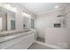 This bathroom features a double vanity with granite countertops and a large walk-in shower at 1033 Marguerite Dr, Lowell, NC 28098