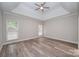 Spacious bedroom with trey ceiling, ceiling fan and two windows providing natural light at 1033 Marguerite Dr, Lowell, NC 28098