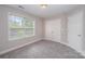 This bedroom features neutral walls, plush carpet, and a window for plenty of natural light at 1033 Marguerite Dr, Lowell, NC 28098