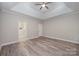 This bedroom features a decorative trey ceiling, fan, and access to an en suite bathroom at 1033 Marguerite Dr, Lowell, NC 28098