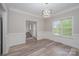 Bright dining room features modern light fixture, stylish flooring, and large window at 1033 Marguerite Dr, Lowell, NC 28098