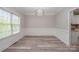 Bright dining room features modern light fixture, stylish flooring, and large window at 1033 Marguerite Dr, Lowell, NC 28098
