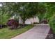 Long driveway leads to a traditional style home with well-manicured landscaping at 1033 Marguerite Dr, Lowell, NC 28098
