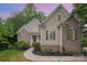 Charming home with brick and vinyl siding, landscaped front yard, and inviting entrance at 1033 Marguerite Dr, Lowell, NC 28098