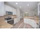 Modern kitchen features granite countertops, stainless appliances, and ample cabinet space at 1033 Marguerite Dr, Lowell, NC 28098