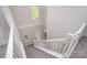View of the home's staircase with a carpeted runner and white railing at 1033 Marguerite Dr, Lowell, NC 28098