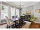 Dining room showcases a modern chandelier, neutral walls, and large windows for abundant natural light at 1038 Gardenia St, Fort Mill, SC 29708