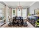Dining room showcases a modern chandelier, neutral walls, and large windows for abundant natural light at 1038 Gardenia St, Fort Mill, SC 29708