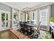 Dining room showcases a modern chandelier, neutral walls, and large windows for abundant natural light at 1038 Gardenia St, Fort Mill, SC 29708