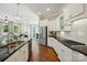 Bright kitchen features white cabinetry, stainless steel appliances, and a large center island with bar seating at 1038 Gardenia St, Fort Mill, SC 29708