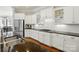 Bright kitchen features white cabinetry, stainless steel appliances, and a large center island with bar seating at 1038 Gardenia St, Fort Mill, SC 29708